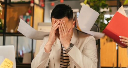 employee sitting at desk feeling overwhelmed and burnout